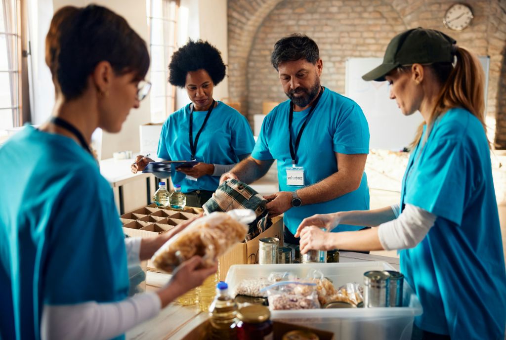 A bustling nonprofit office with workers and volunteers engaged in advocacy and direct community services, representing the vital work nonprofits do to sustain communities.